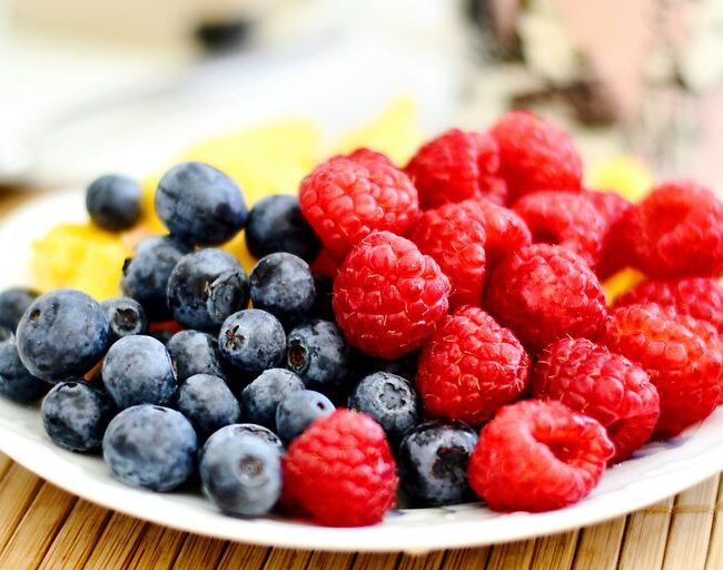 strawberries and blue berries on palte