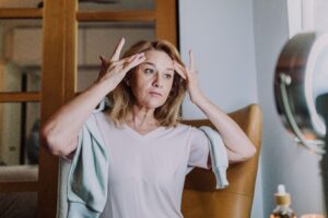 An older woman in her 40s, who's struggling with perimenopause is practicing a healthy morning routine